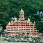 A group practicing yoga as part of a 7-day Uttarakhand itinerary overlooking the Ganges.
